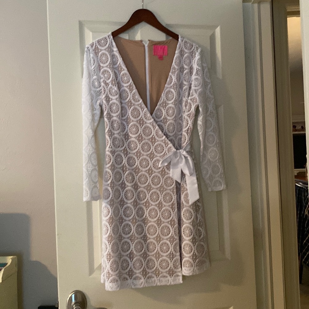 White Lilly dress with nude lining.  Faux wrap, back zip